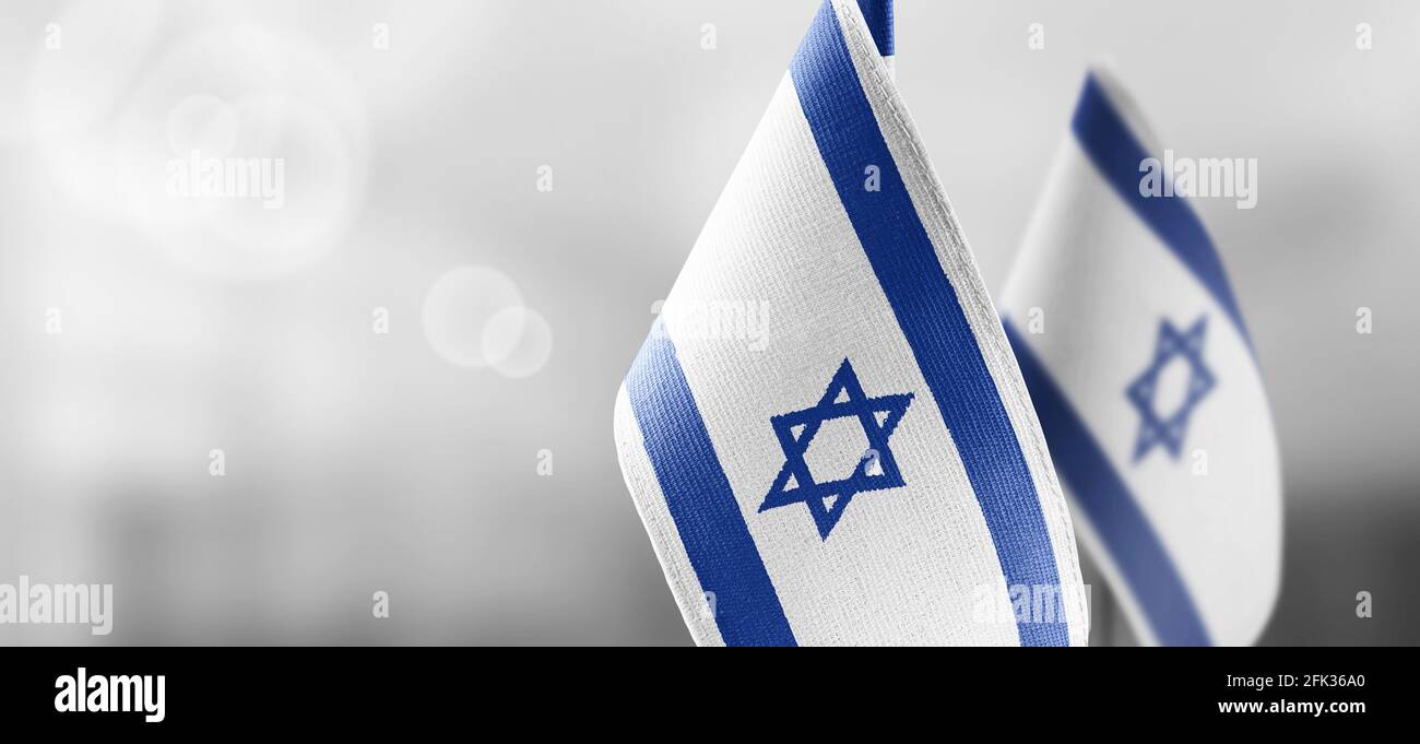 Small national flags of the Israel on a light blurry background Stock Photo