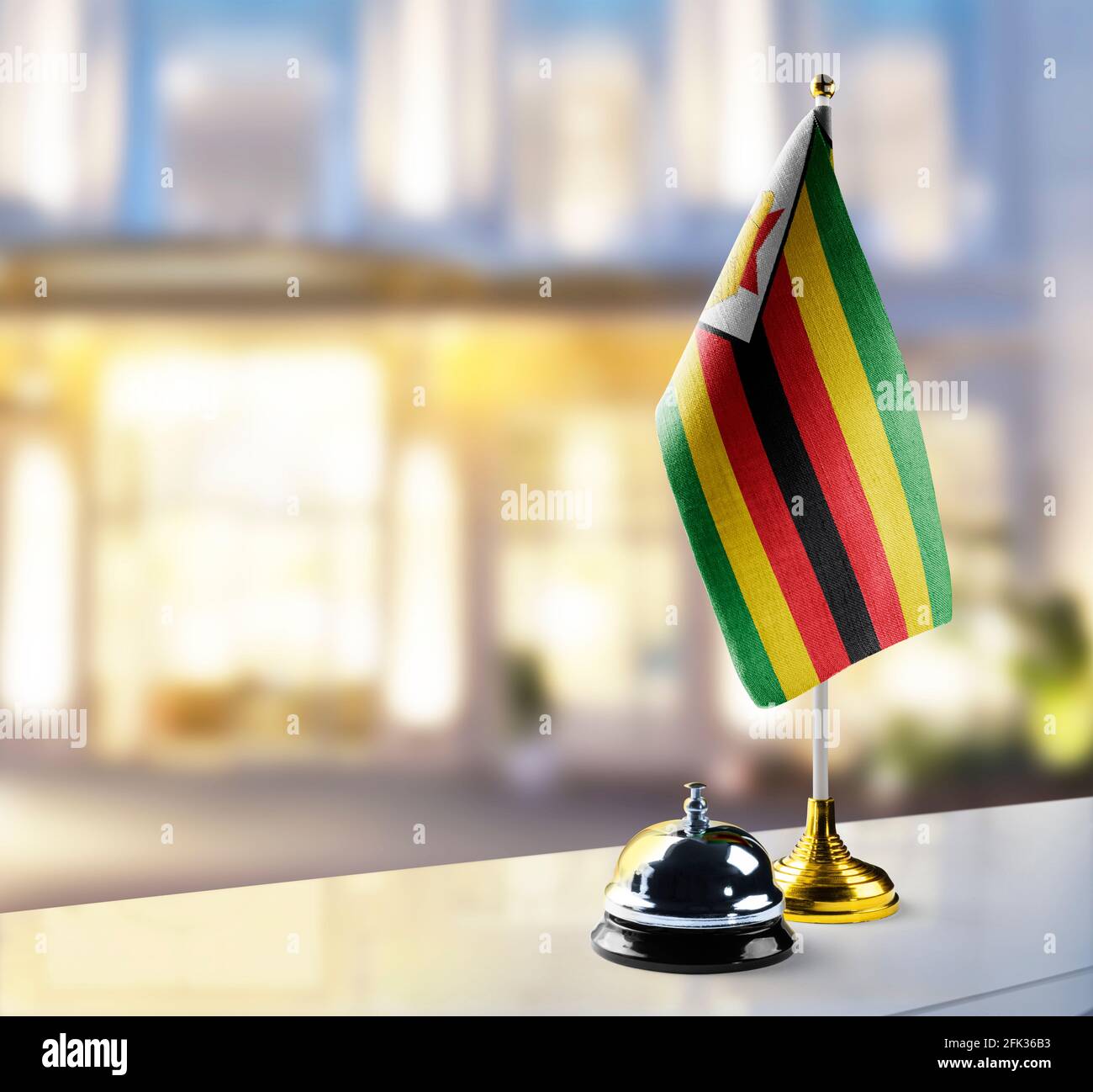 Zimbabwe flag on the reception desk in the lobby of the hotel Stock