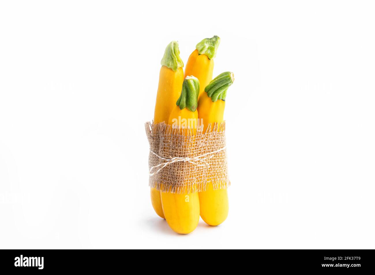 Packed Summer Squash Zucchini, Yellow Colored Gourd Also Known As Courgette, Baby Marrow, Indian Jugni Sabzi Or Jugnu Petha Sabji Tied In Burlap Cloth Stock Photo