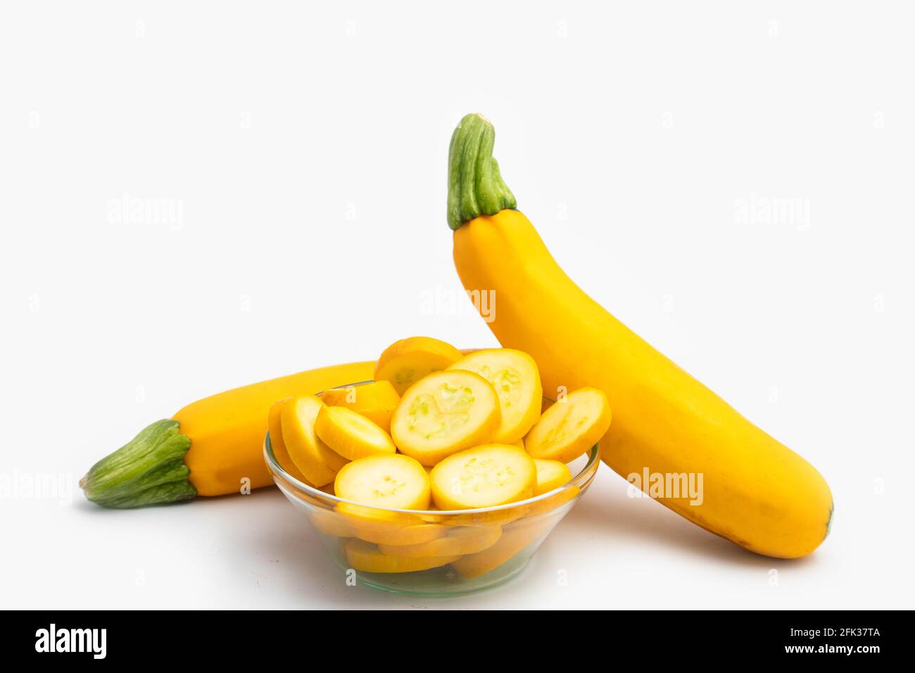 Whole And Sliced Pieces Of Summer Squash Zucchini, Yellow Colored Gourd Also Known As Courgette, Baby Marrow, Indian Jugni Sabzi Or Jugnu Petha Sabji Stock Photo