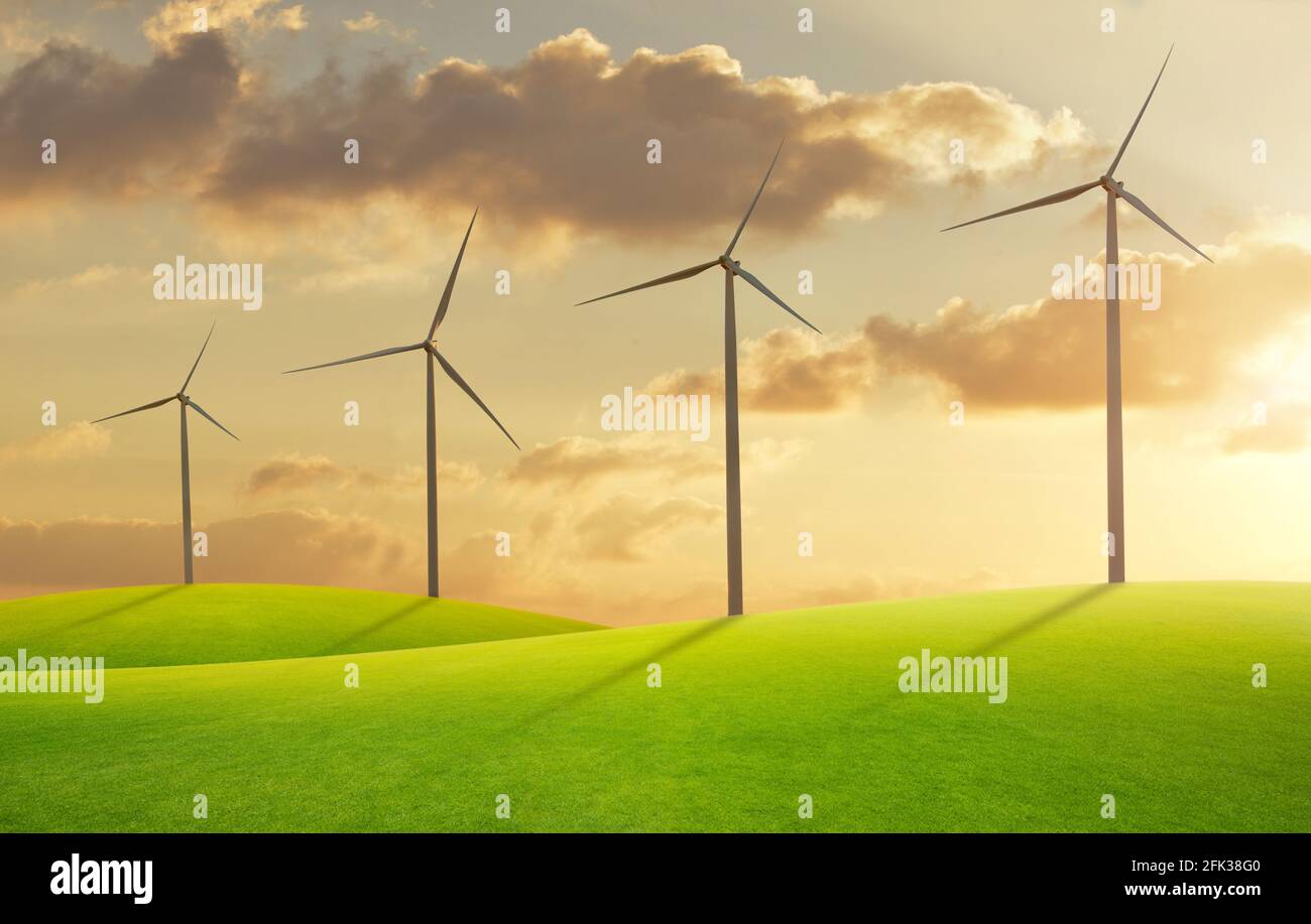 Wind turbine in green field at sunset Stock Photo - Alamy