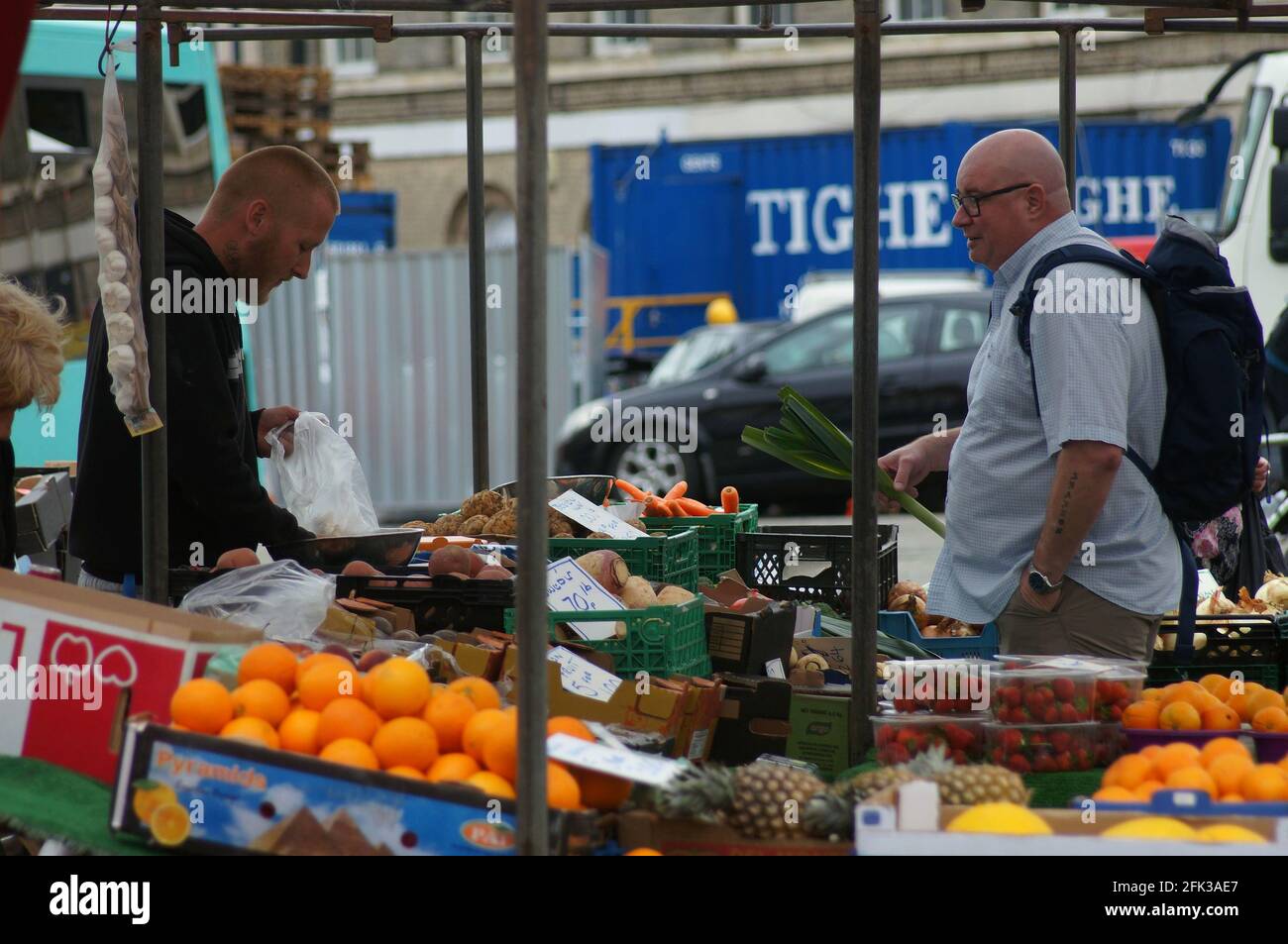 a shopper buying local produce at an outdoor market stall Stock Photo