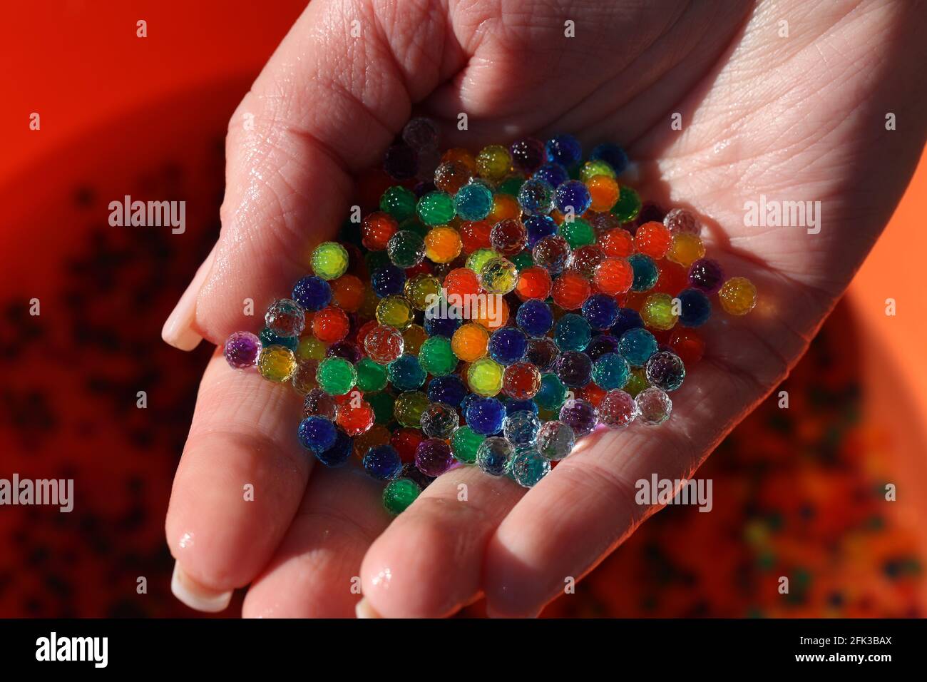 Small colorful plastic balls in the hands Stock Photo Alamy
