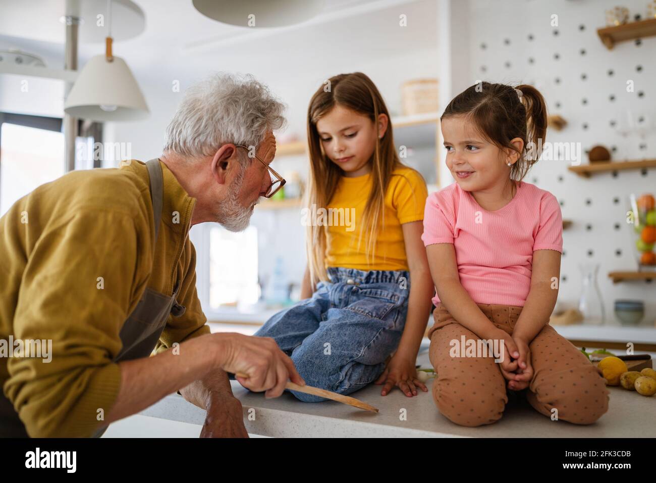Grandfather is scolding his grandchildrens girls. Family, punishment, discipline concept Stock Photo