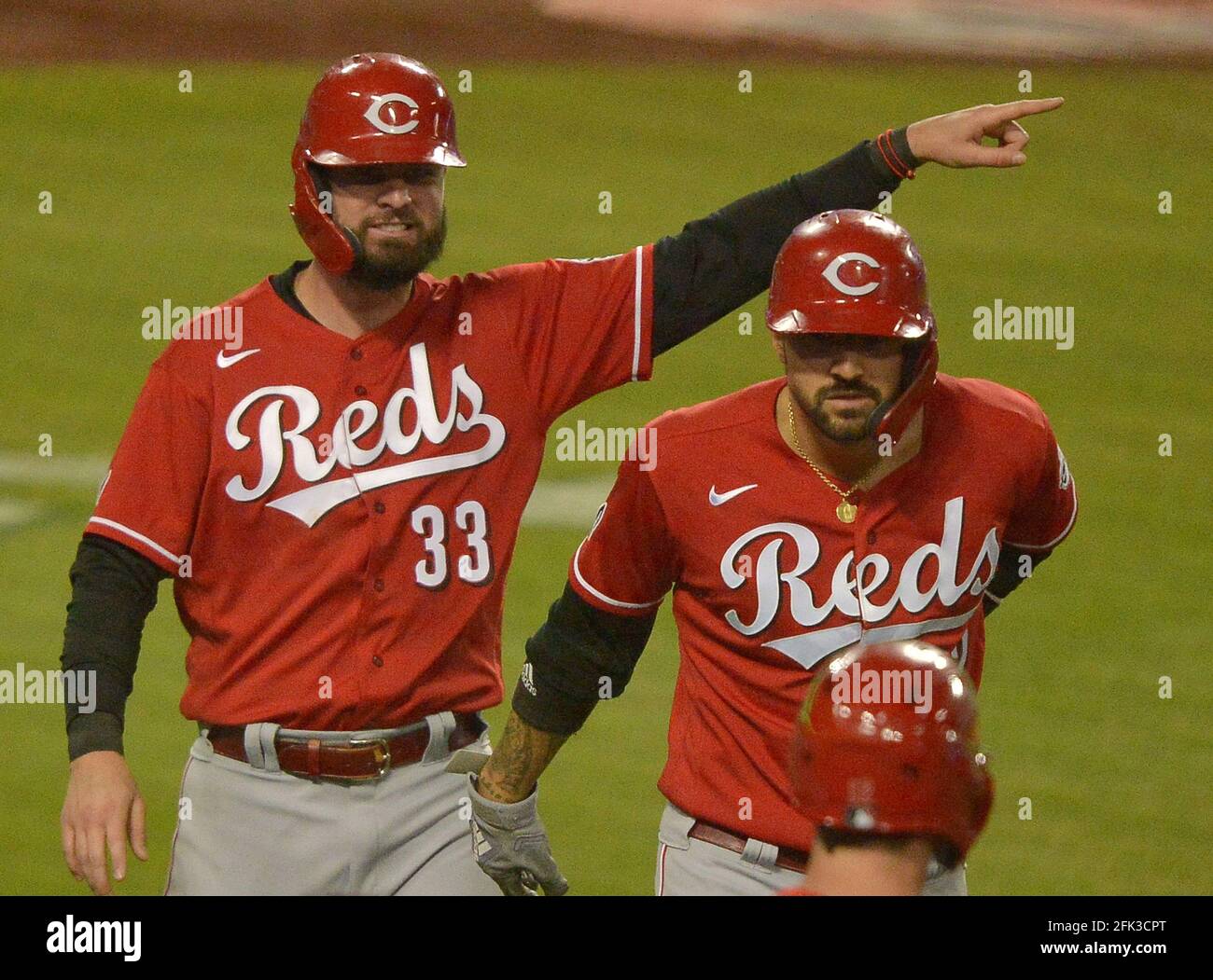 Los Angeles, United States. 28th Apr, 2021. Cincinnati Reds' Jesse Winker  (33) and Nick Castellanos (2) celebrate after scoring on Joey Votto's  two-out, two-run double off Los Angeles Dodgers' relief pitcher Scott