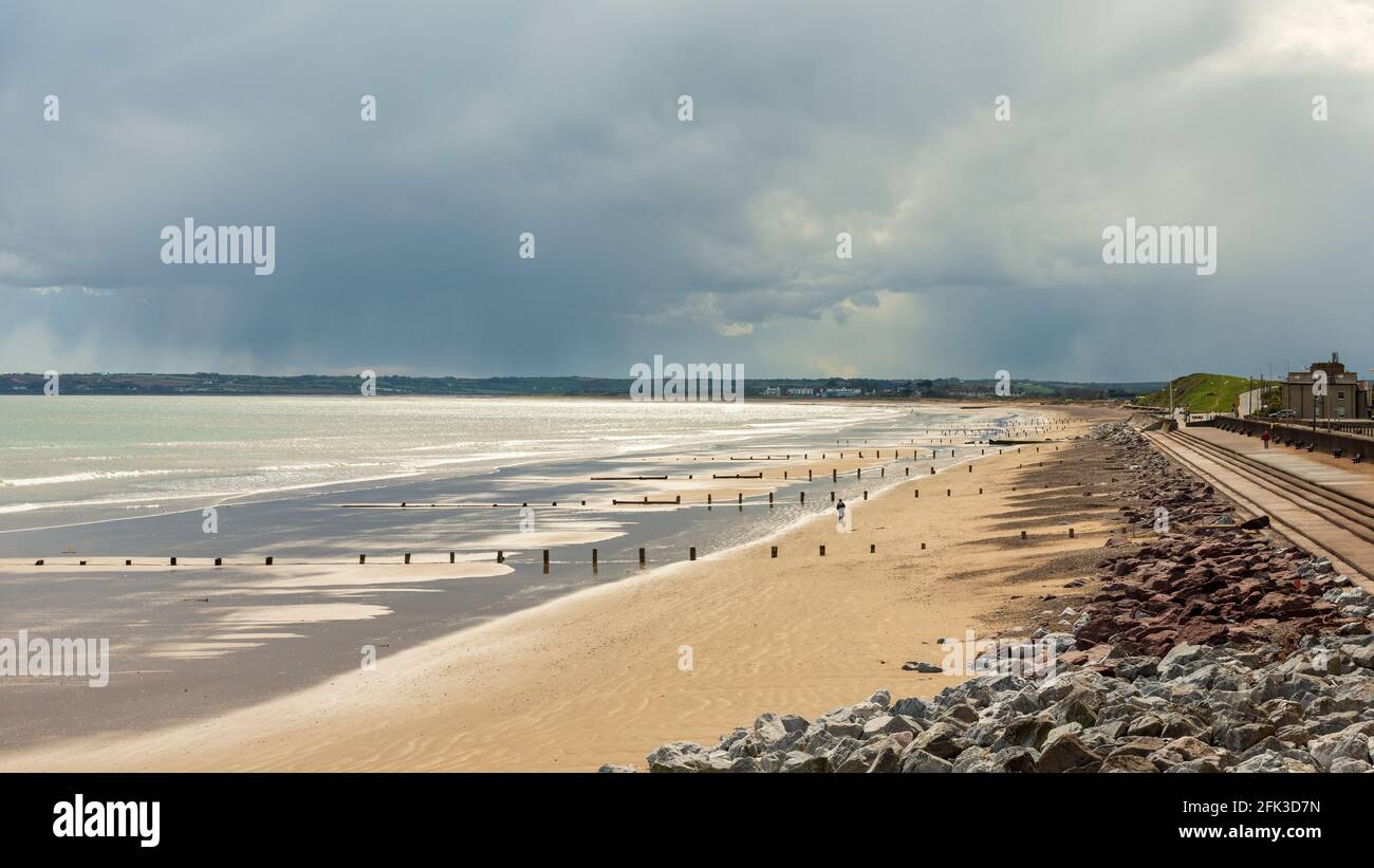 The empty Youghal Strand and promenade out of season looking southward to the Knockadoon Head in Youghal, County Cork, Ireland as of April 2016 Stock Photo
