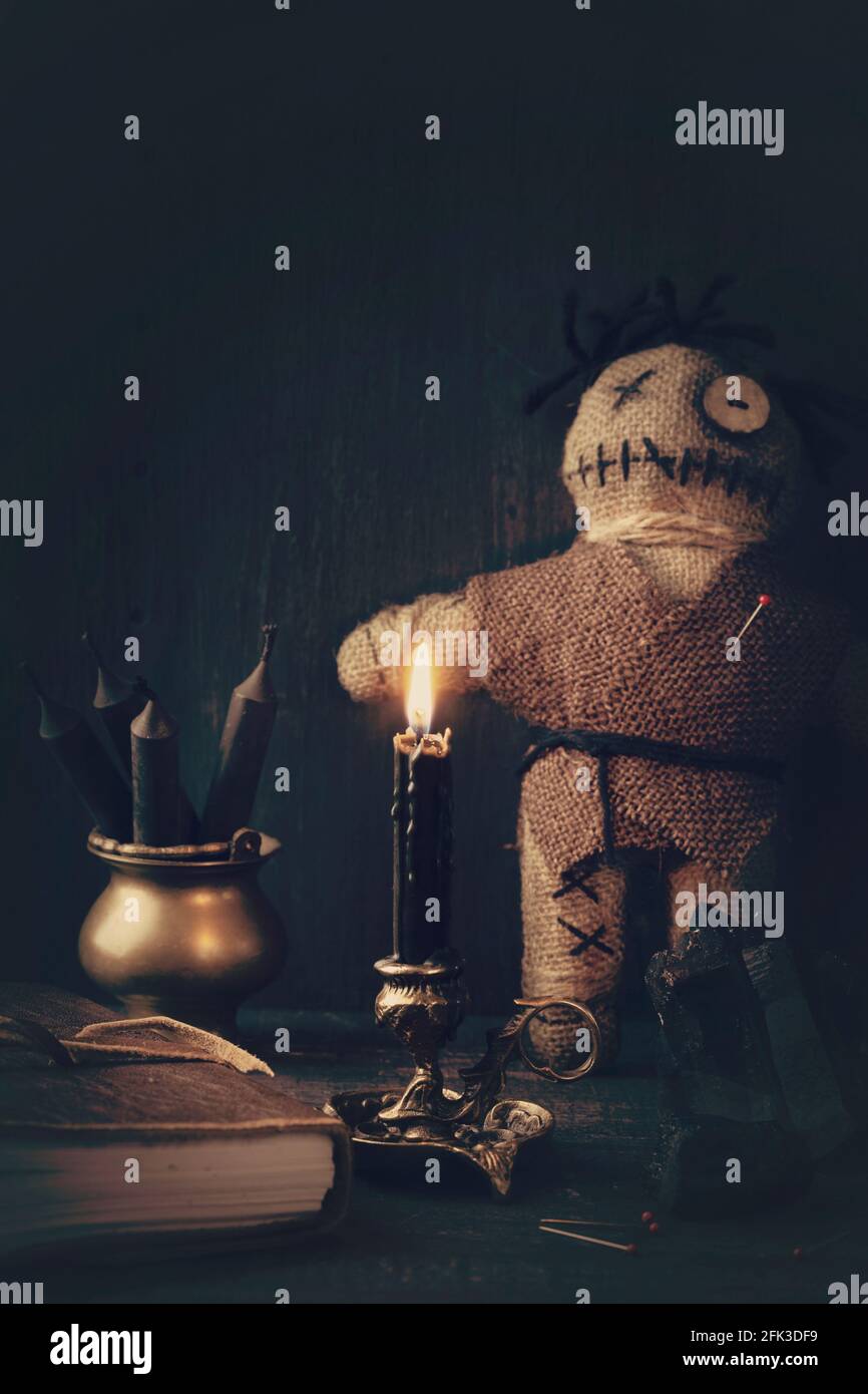 Voodoo doll with pins on a wooden background Stock Photo - Alamy
