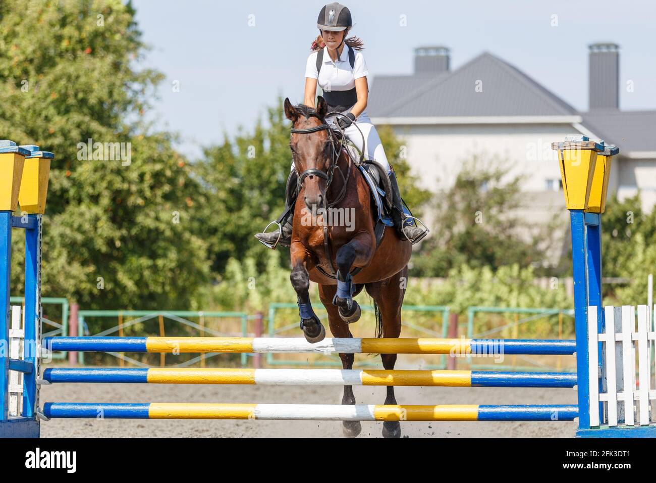 Teen girl jumping horse on her show jumping course Stock Photo