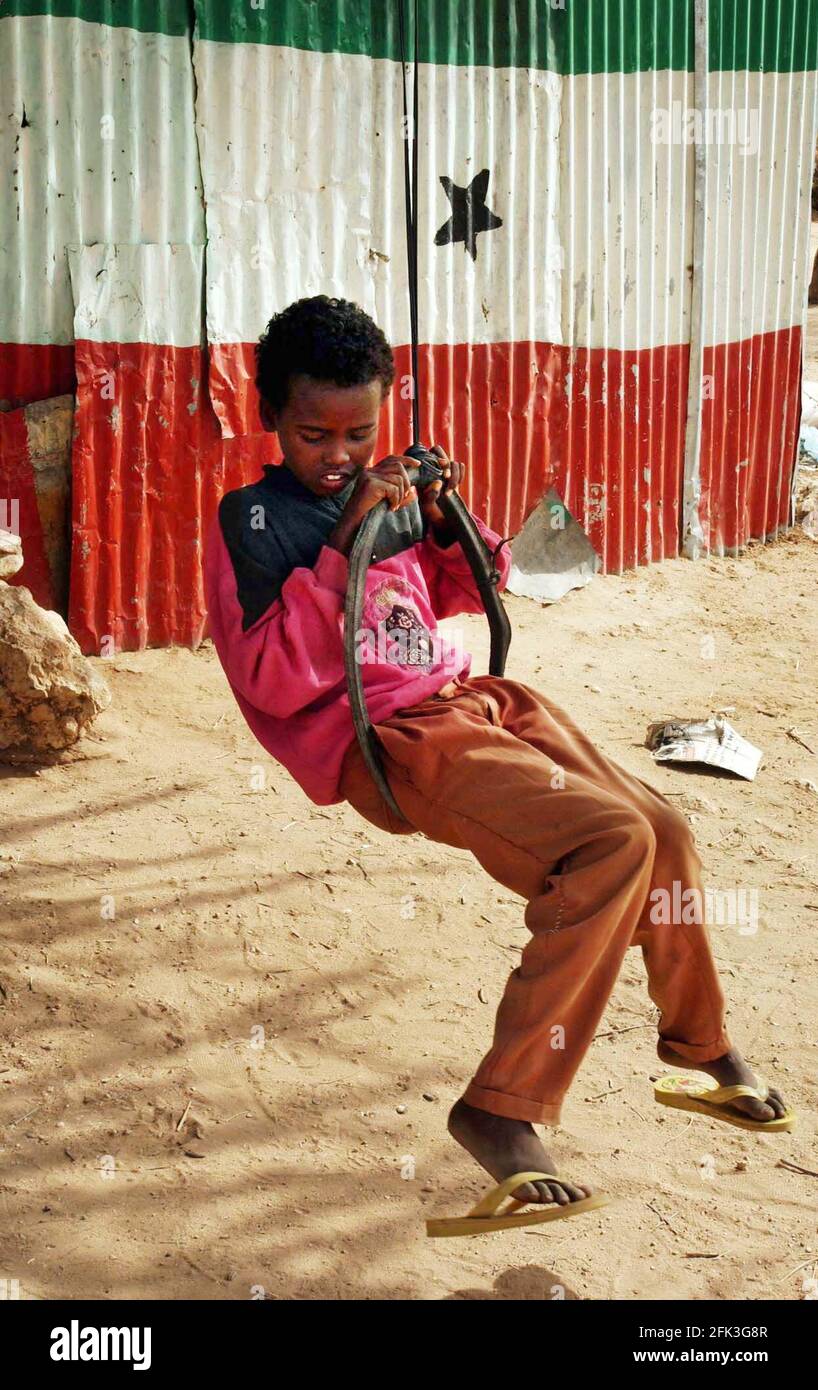 A BOY FROM AN IDP FAMILY PLAYS IN HARGEISA SOMALILAND.2/7/05 TOM PILSTON Stock Photo