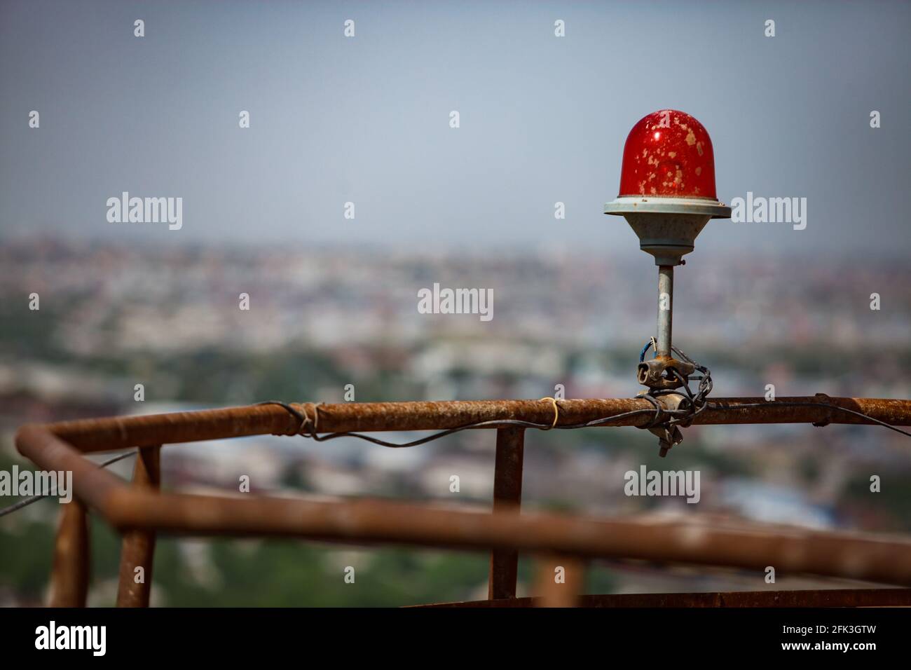 Aircrafts and airplanes warning red light signal lamp on building's roof. Stock Photo