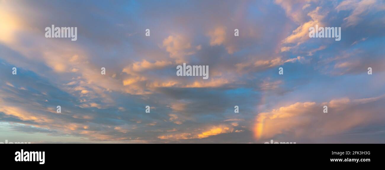 Dramatic sunset sky covered by gentle golden colored cloud  Stock Photo
