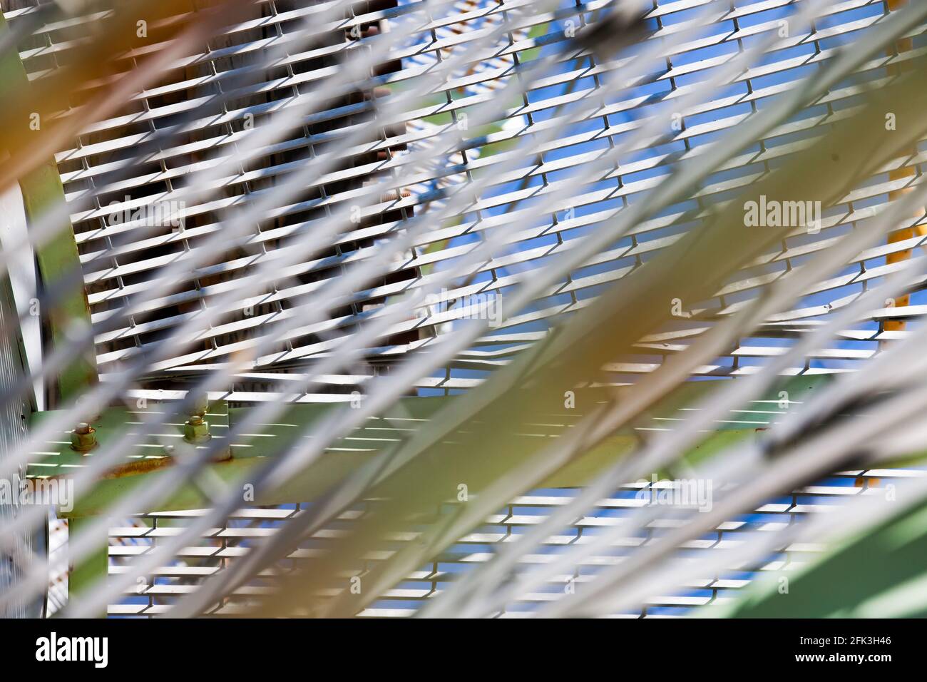 Abstract metal grid on oil processing plant. Oil distillation tower (refining column). Close-up. Focus on background. Stock Photo