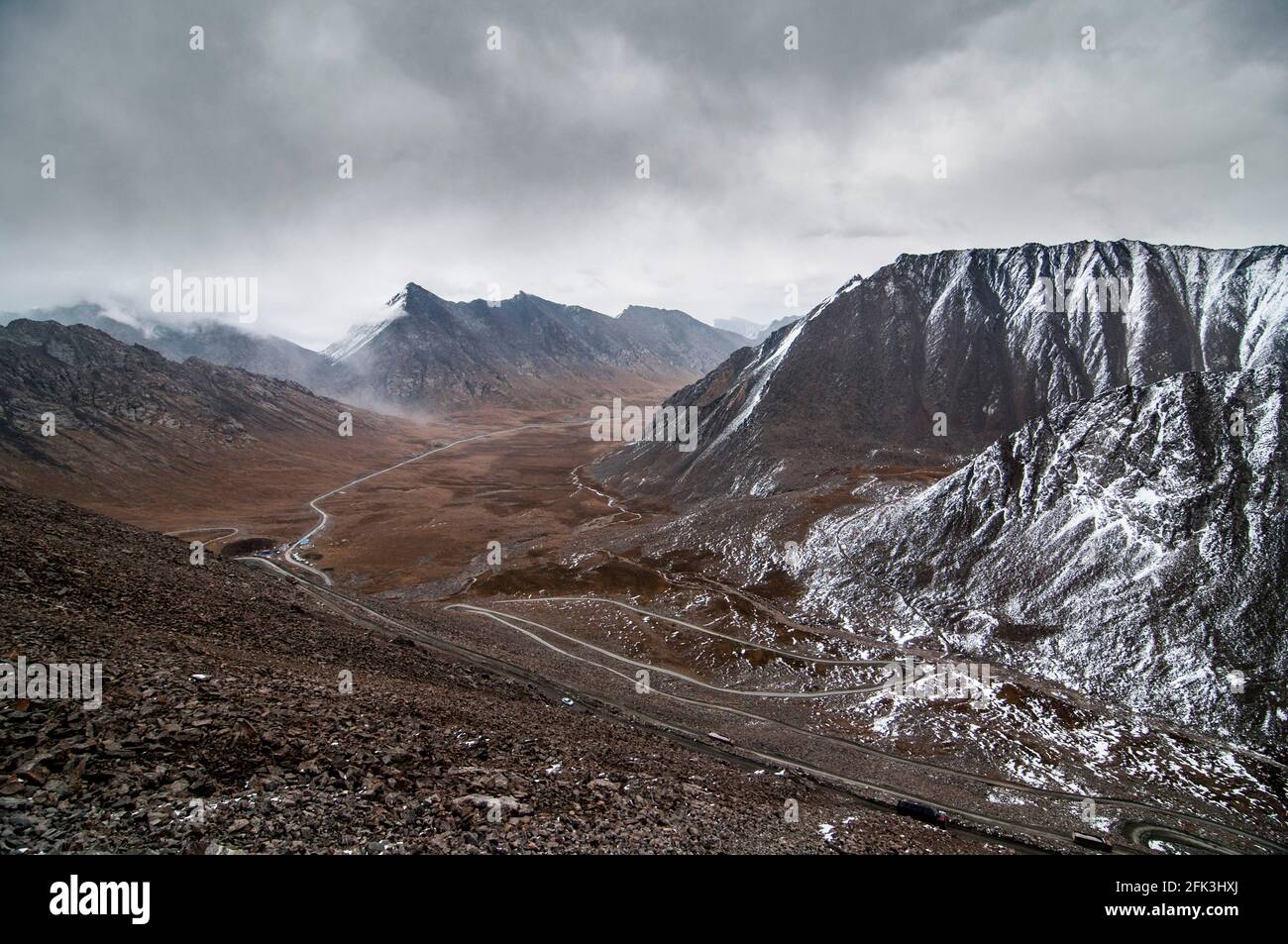 A cold weather front moves across the mountains along the G216 Highway connecting Urumuqi to the Bayingolin Prefecture across the Tianshan mountains in Xinjiang, China, PRC. © Time-Snaps Stock Photo