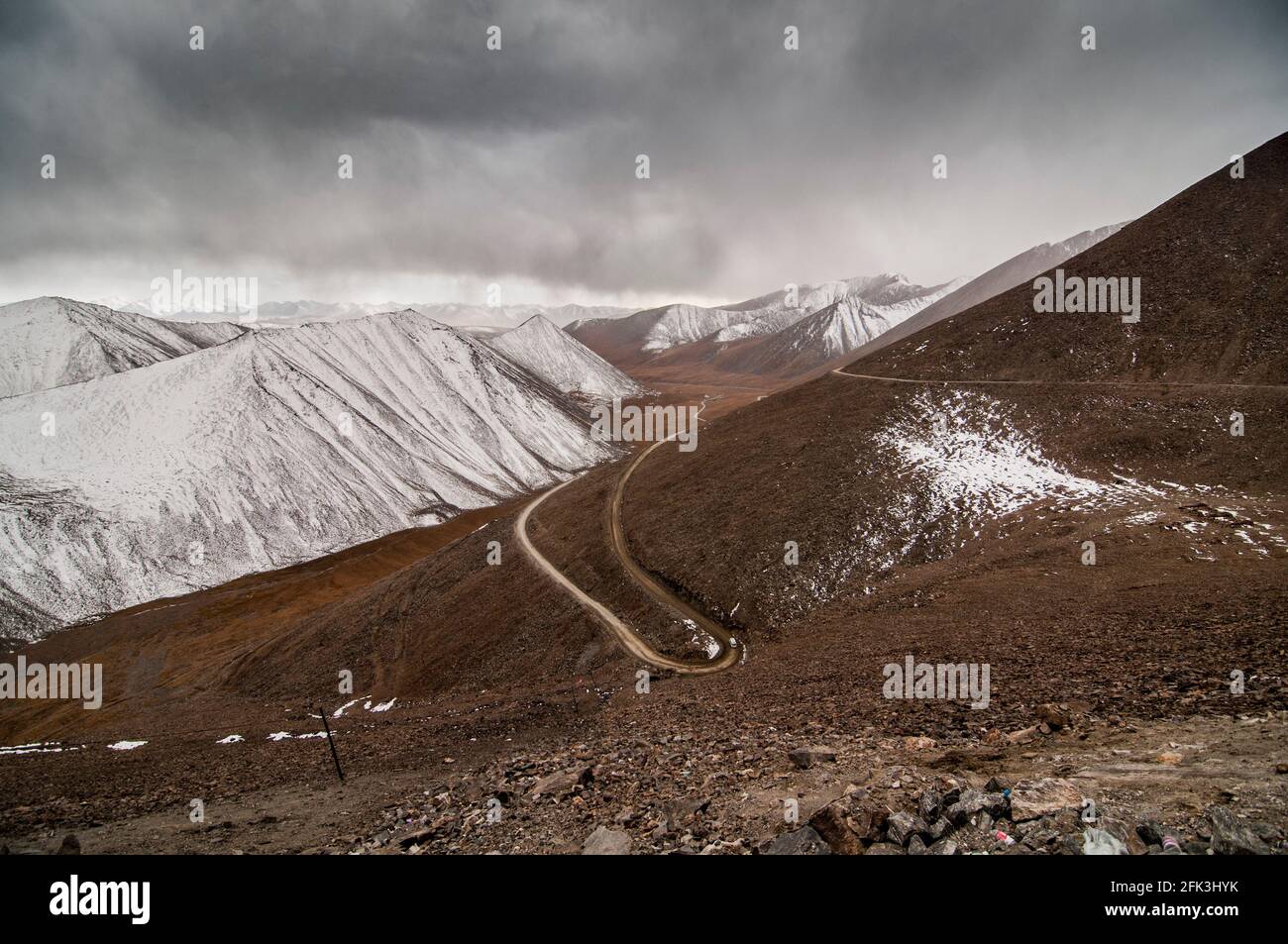 A cold weather front moves across the mountains along the G216 Highway connecting Urumuqi to the Bayingolin Prefecture across the Tianshan mountains in Xinjiang, China, PRC. © Time-Snaps Stock Photo
