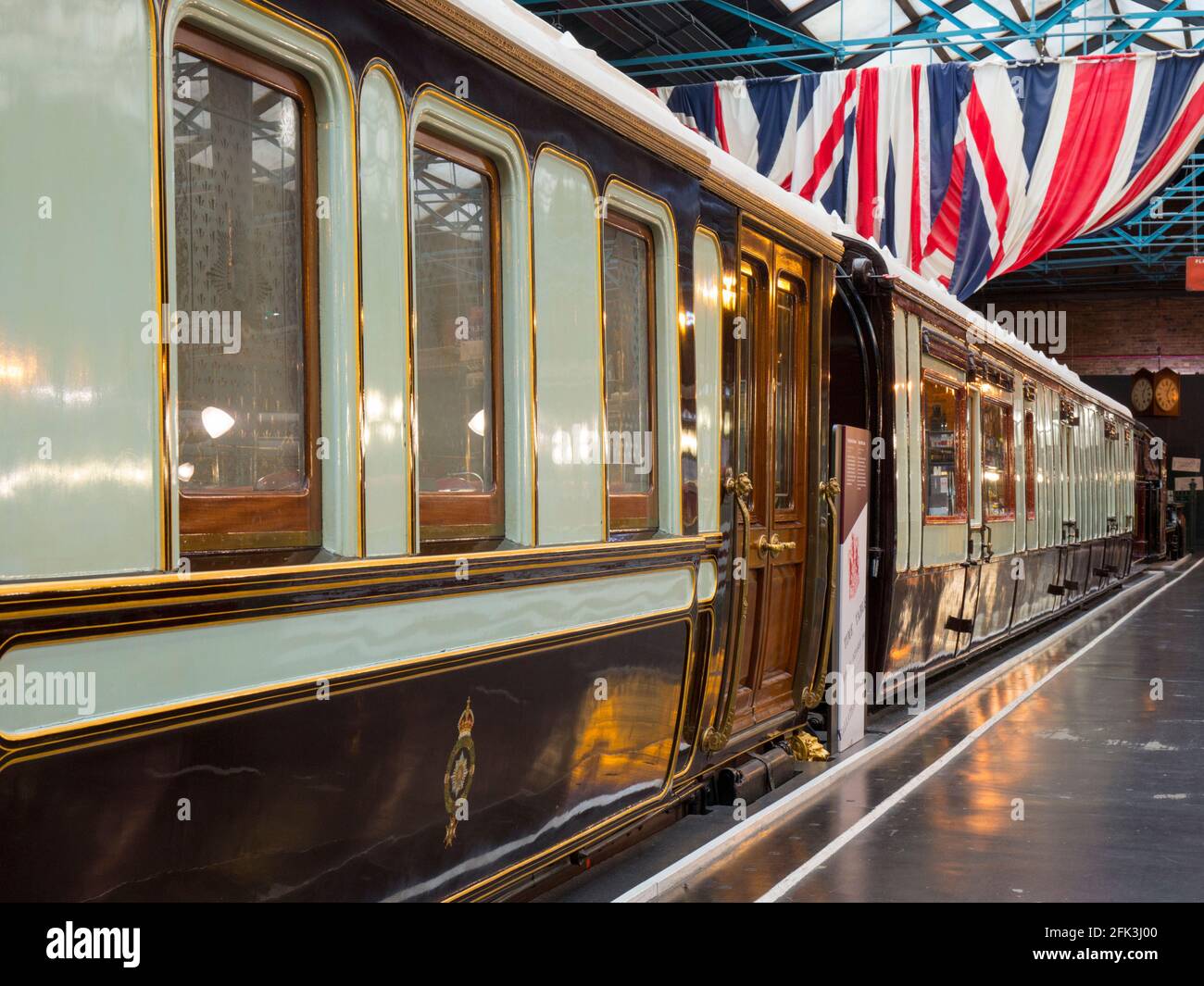 York, North Yorkshire, England. Royal train carriages on display beneath Union Jacks at the National Railway Museum. Stock Photo