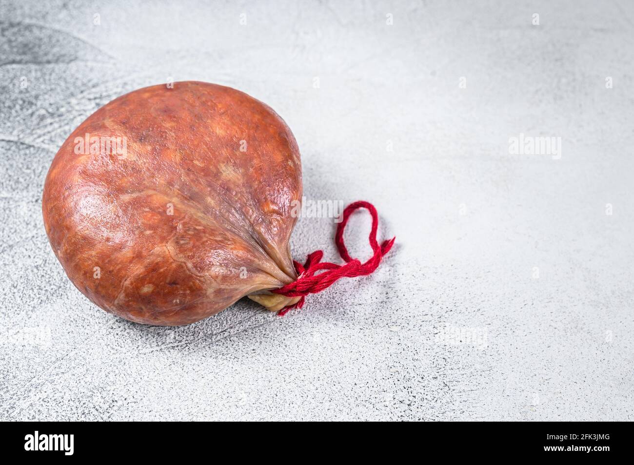 Sobrassada cured meat sausage from ground pork, paprika and spices. White background. Top view