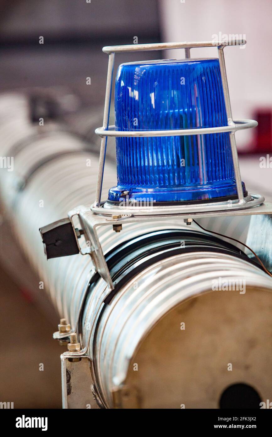 Blue warning light on truck. Carbuilding plant Blurred