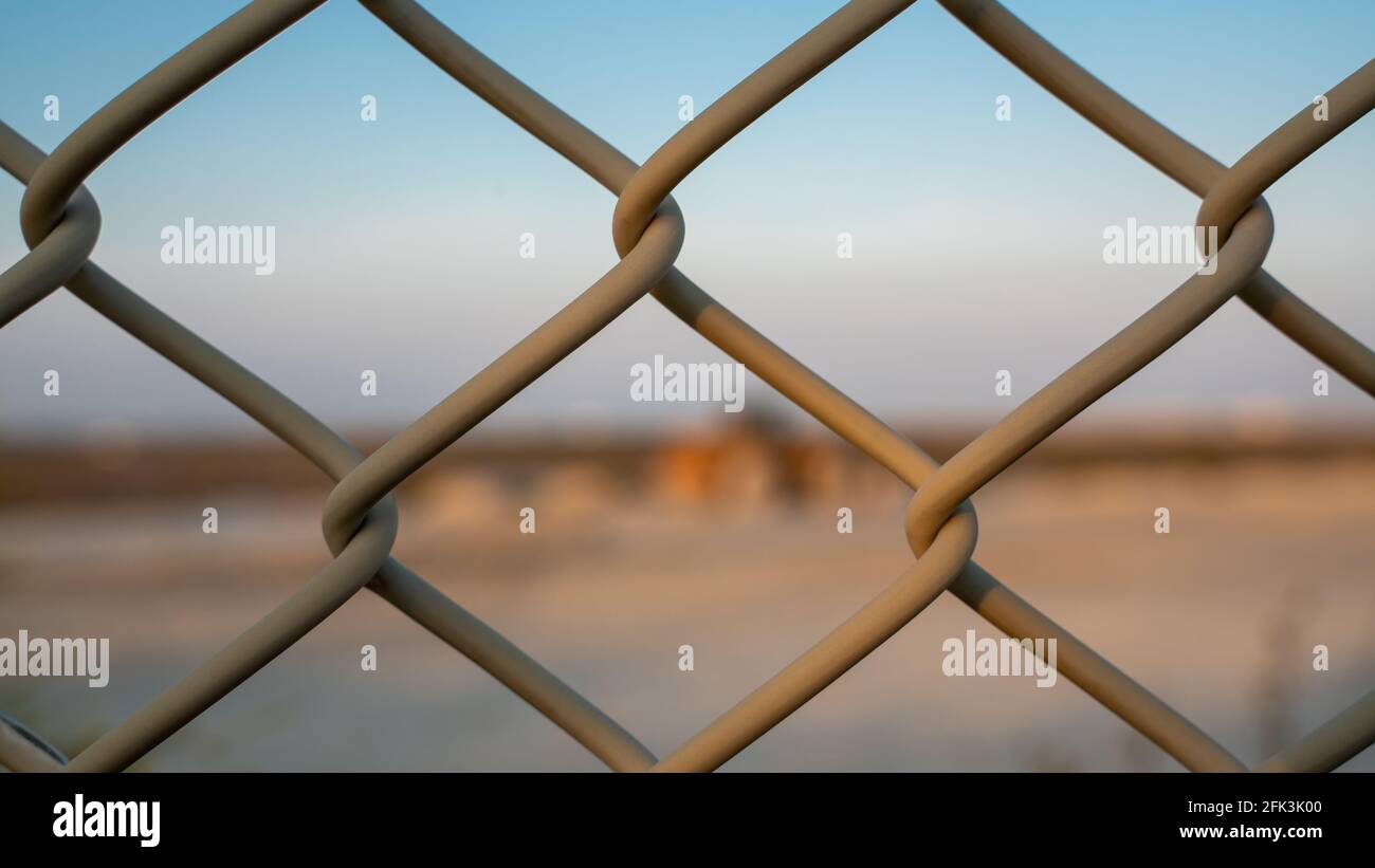 Background image of a garden chain link fence fence Stock Photo - Alamy