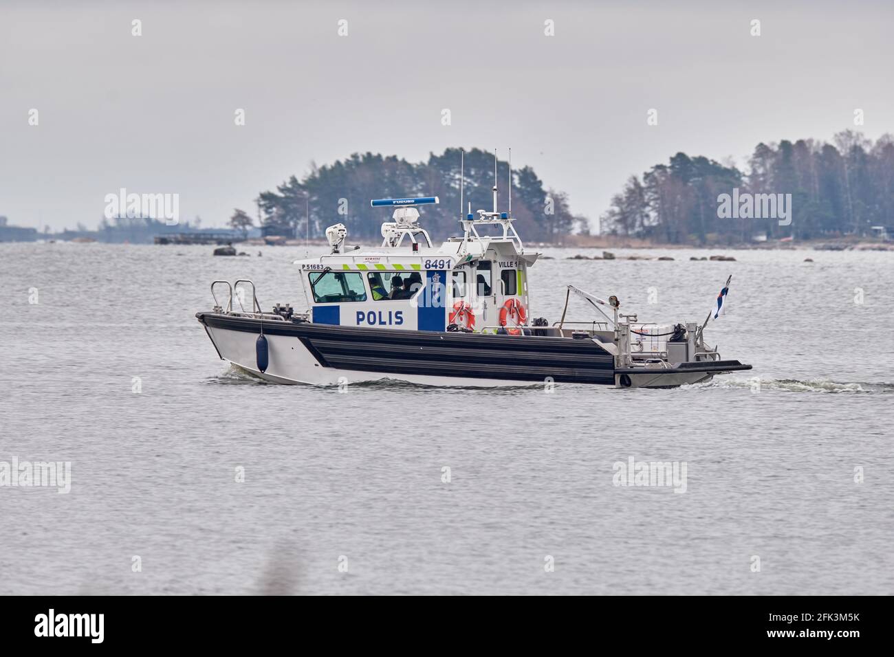 Espoo, Finland - April 27, 2021: Finnish Police boat is moving in the Baltic sea near the seashore Stock Photo