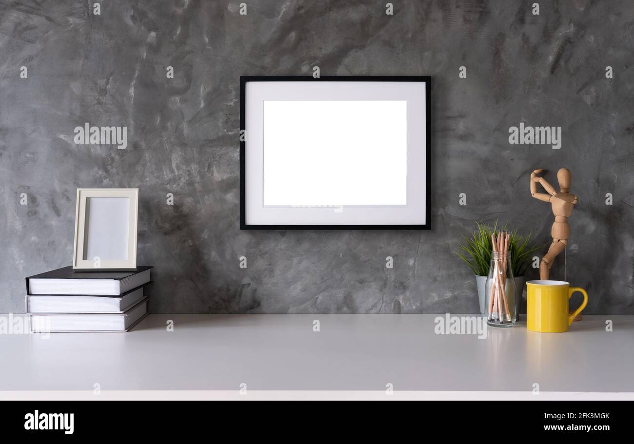 White desk with photo frame, office supplies, book natural leaf inin design vase Stock Photo
