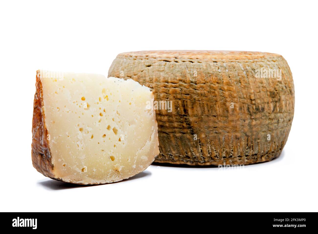 a piece of aged pecorino cheese with cheese wheel in white background