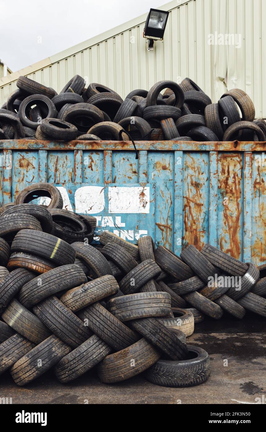 Pile of tyres from scrapped cars in vehicle recycling centre Stock Photo