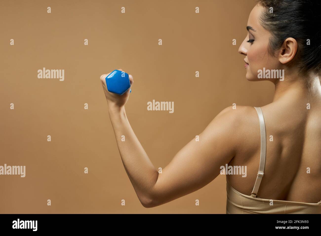 Athletic young woman doing exercise with dumbbell Stock Photo