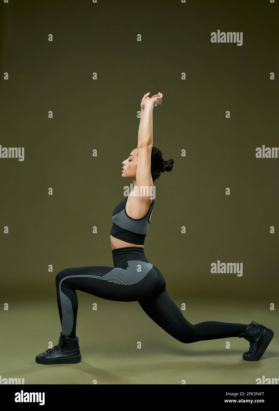 Sporty young woman doing exercise in studio Stock Photo