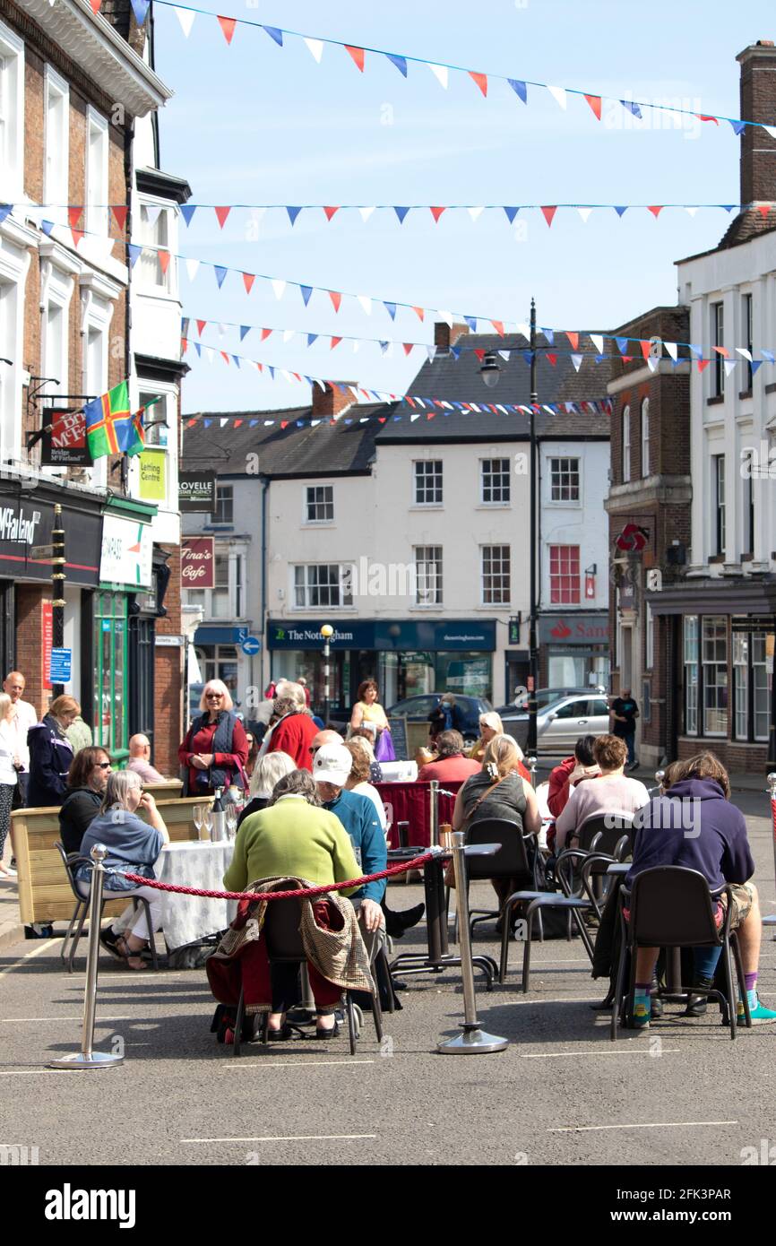People eating outside in the cormarket area of louth, Lincolnshire during Covid restrictions in April 2021 Stock Photo