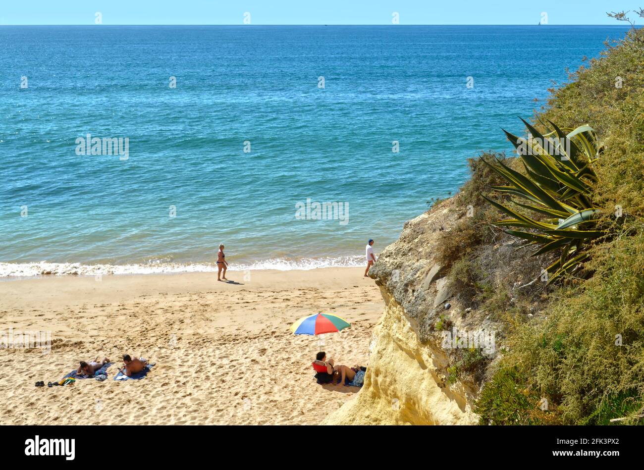 Tourists enjoying sunny weather on Armacao De Pera Beach on the Algarve coast Stock Photo