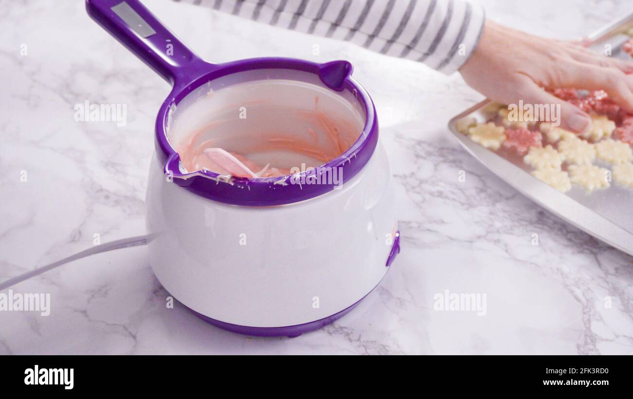Step by step. Melting chocolate candy melts in an electric candy melting pot Stock Photo - Alamy