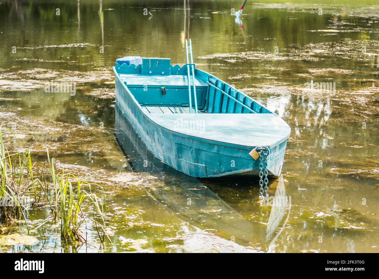 Wooden boat moored on the lake shore Stock Photo - Alamy