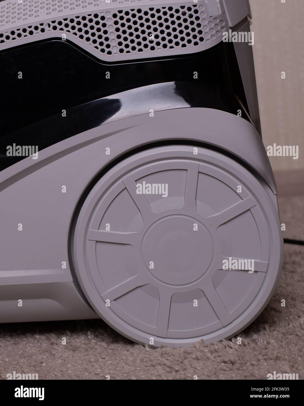 Electrical engineering. Washing vacuum cleaner wheels. Gray wheel. A close up of a toy. Stock Photo