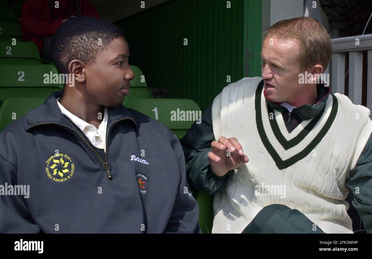 Andy Flower captain of the Zimbabwe cricket team with a young person