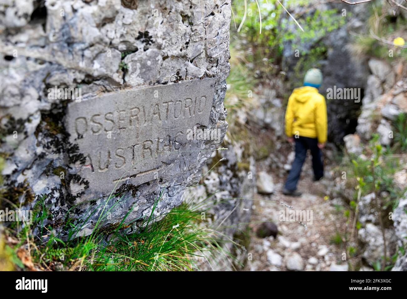Young boy exploring the First World War Italian army fortifications, caverns and trenches at mount Sabotin, Slovenia Stock Photo