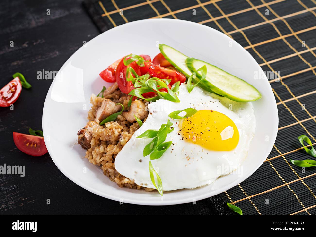 Nasi Goreng. Indonesian chicken fried rice on dark background. Nasi