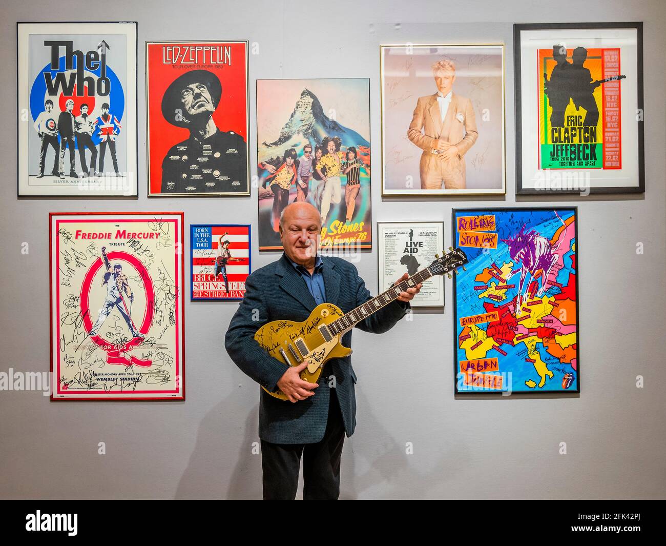 London, UK. 28th Apr, 2021. Harvey Goldsmith with the top lot of the sale, a multi-signed Les Paul Gold Top Guitar (signed at Bob Dylan's The 30th Anniversary Concert), Estimate £10,000-15,000 - Preview of the Harvey Goldsmith collection of entertainment memorabilia at Bonhams, New Bond Street, London. It will be part of the Entertainment Memorabilia sale in the Knightsbridge saleroom on 5 May. His collection is made up of 41 lots, and estimates range from £200-10,000. Credit: Guy Bell/Alamy Live News Stock Photo