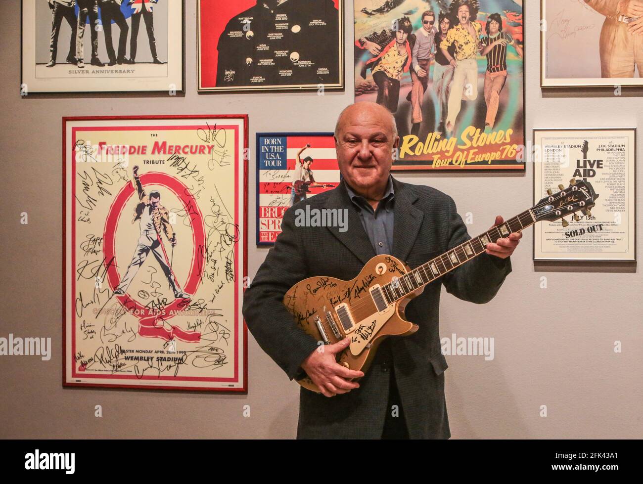 London UK 28 April 2021 Harvey Goldsmith holding the a Les Paul Gold Top Guitar signed at Bob Dylan’s 30th Anniversary Concert by stars there on the night - George Harrison, Eric Clapton, Stevie Wonder and Dylan himself (estimate: £10,000 - 15,000).Paul Quezada-Neiman/Alamy Live News Stock Photo