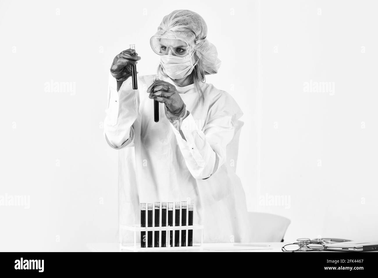 scientific discovery. healthcare and medicine. woman with test tubes in hospital lab. make blood test for virus. vaccine against sars. infection Stock Photo