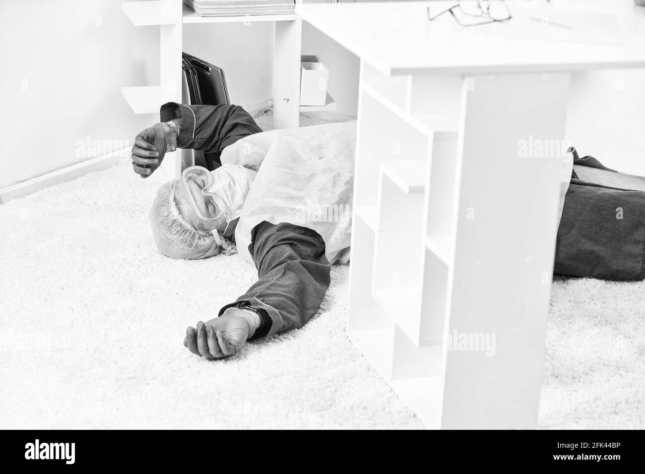 Man passed out. Shortness of breath. Man in protective equipment lay on floor. Severe condition