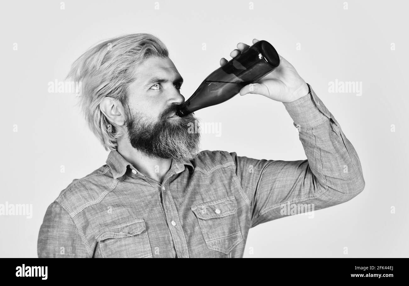 Beer is Full of a new Skill. stylish handsome man drinking from beer bottle. clear pour water. Party with friends. Brutal bearded man drink beer from Stock Photo