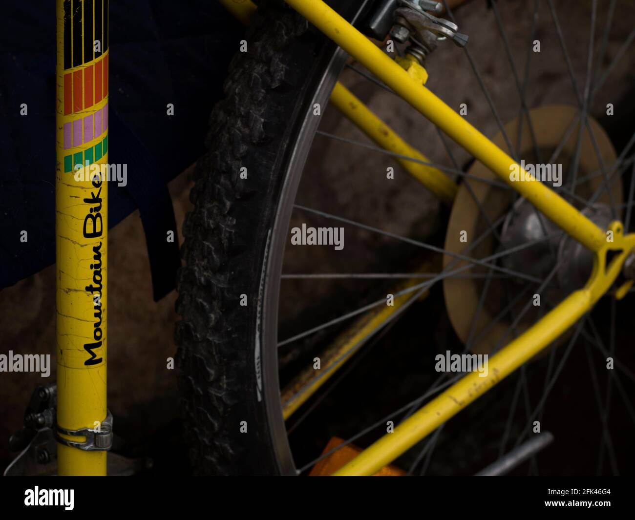 Vintage yellow mountain bike detail of frame and wheel. Stock Photo