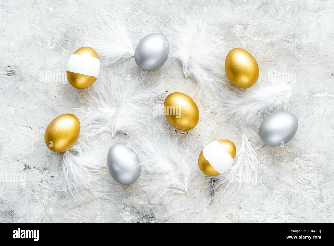 Golden and silver Easter eggs with white feather Easter decoration