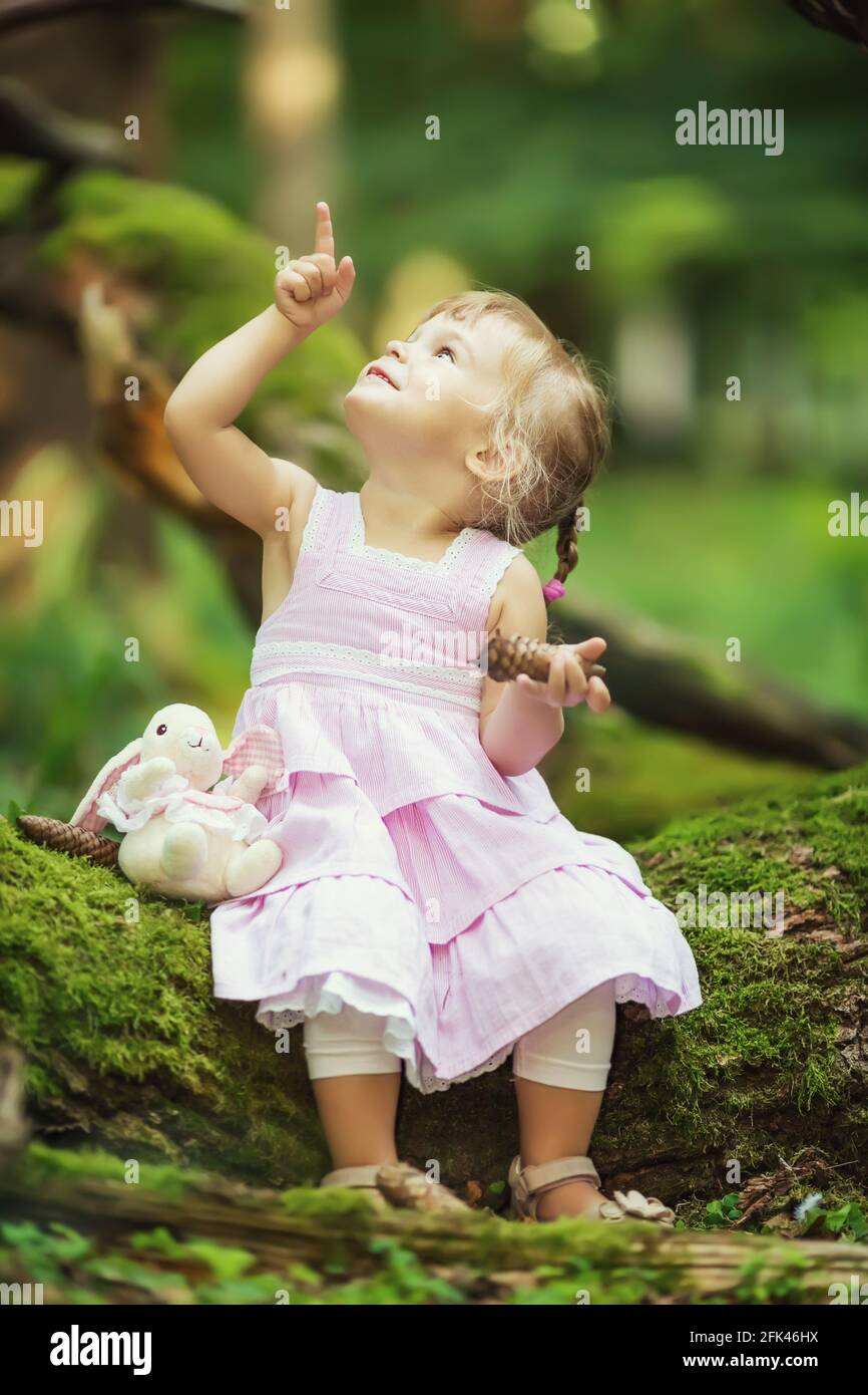 Little girl in the dark green forest Stock Photo - Alamy