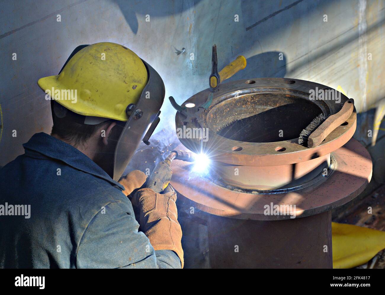 worker makes a soldered joint in a shipyard Stock Photo Alamy