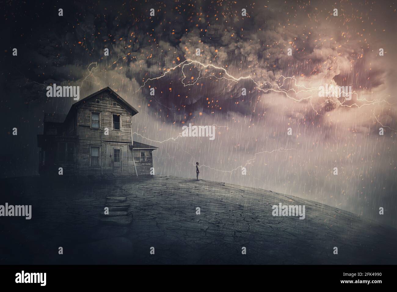 Creepy storm scene with scary lightnings over a ghost land with a haunted house and a person phantom standing under rain. Desolated mansion facing a h Stock Photo