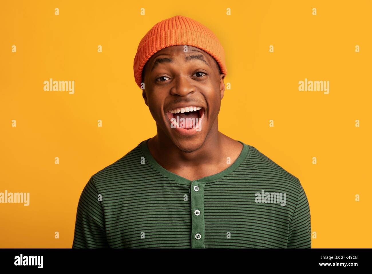 Portrait Of Excited Black Millennial Guy Opening Mouth With Amazement