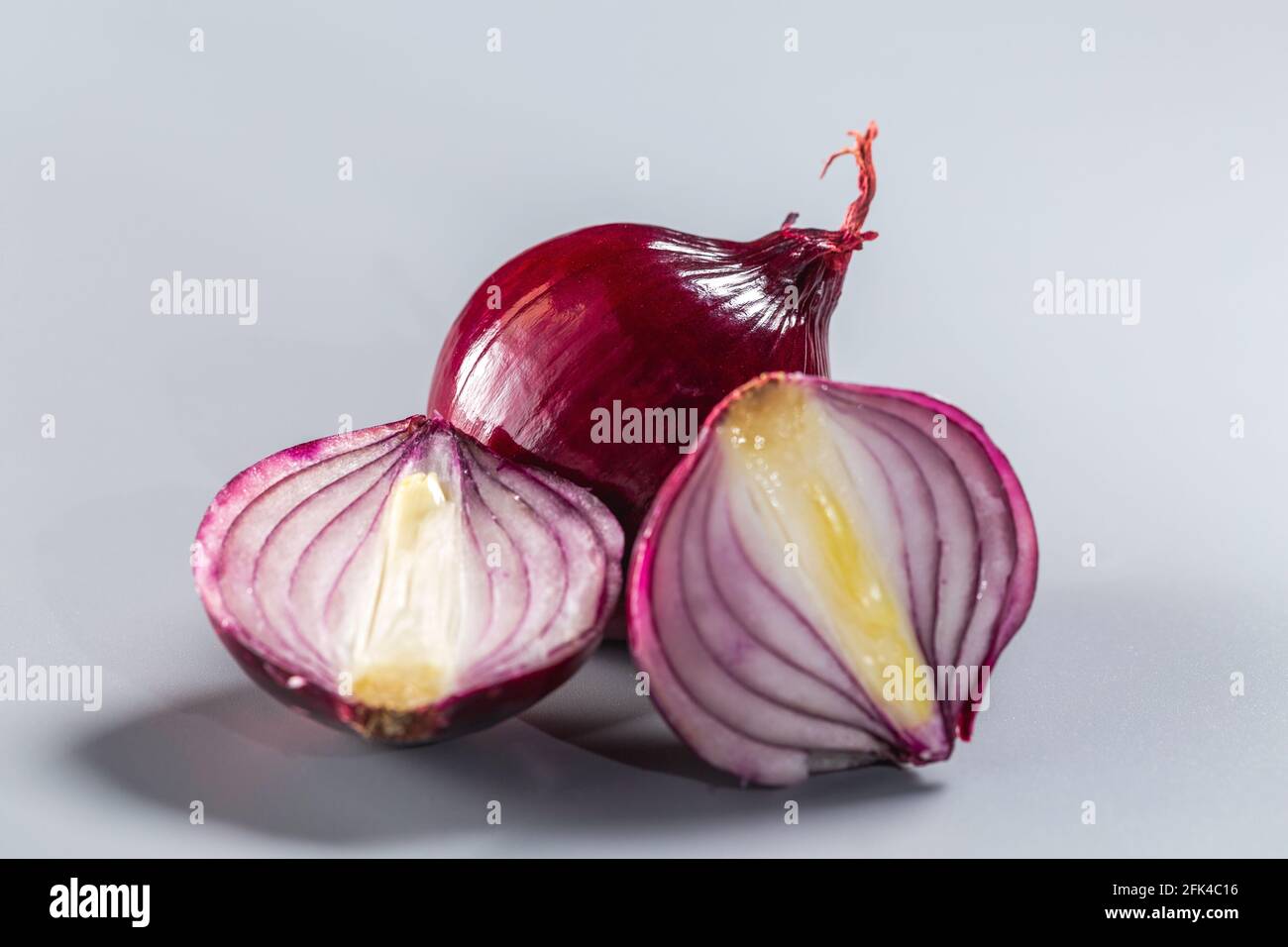 Red onions isolated on gray background. Stock Photo