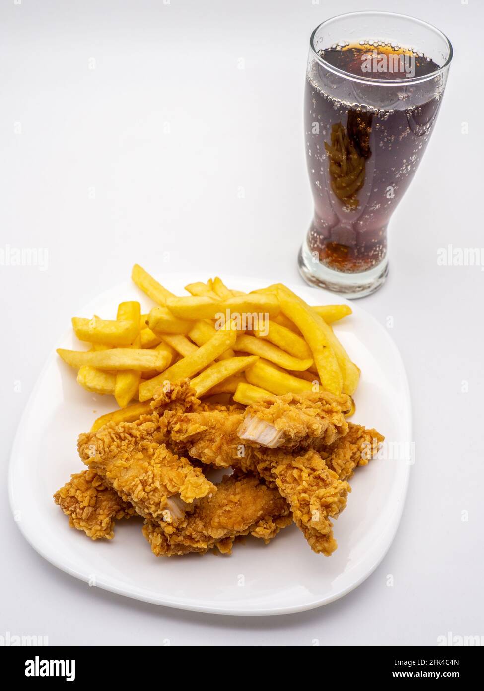 Fried chicken wings, french fries, and a glass of soda on isolated on a