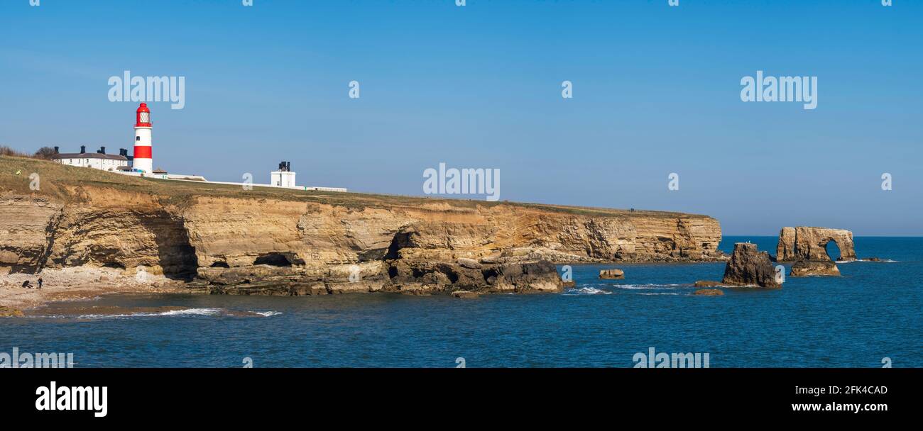 Panorama of beach & cave in cliffs at Byer's Hole / The Wherry with Souter Lighthouse. Between Marsden & Whitburn  South Tyneside Coast Tyne and Wear Stock Photo